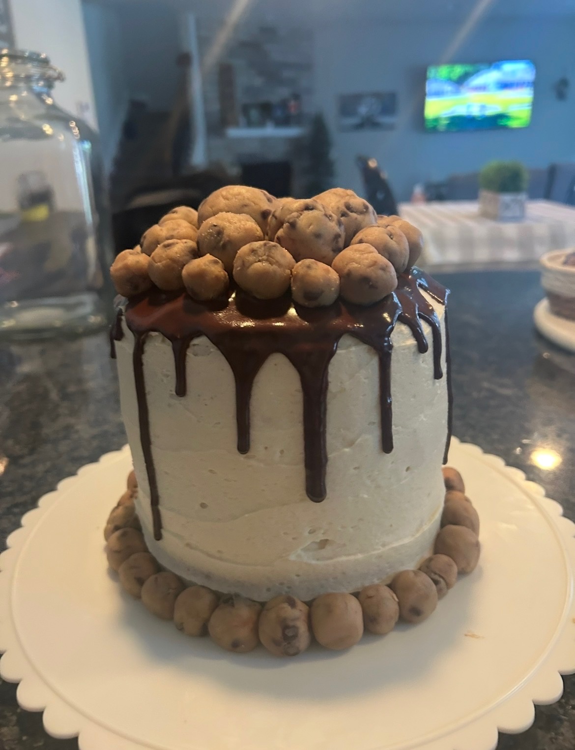 Chocolate drip cake topped with cookie dough